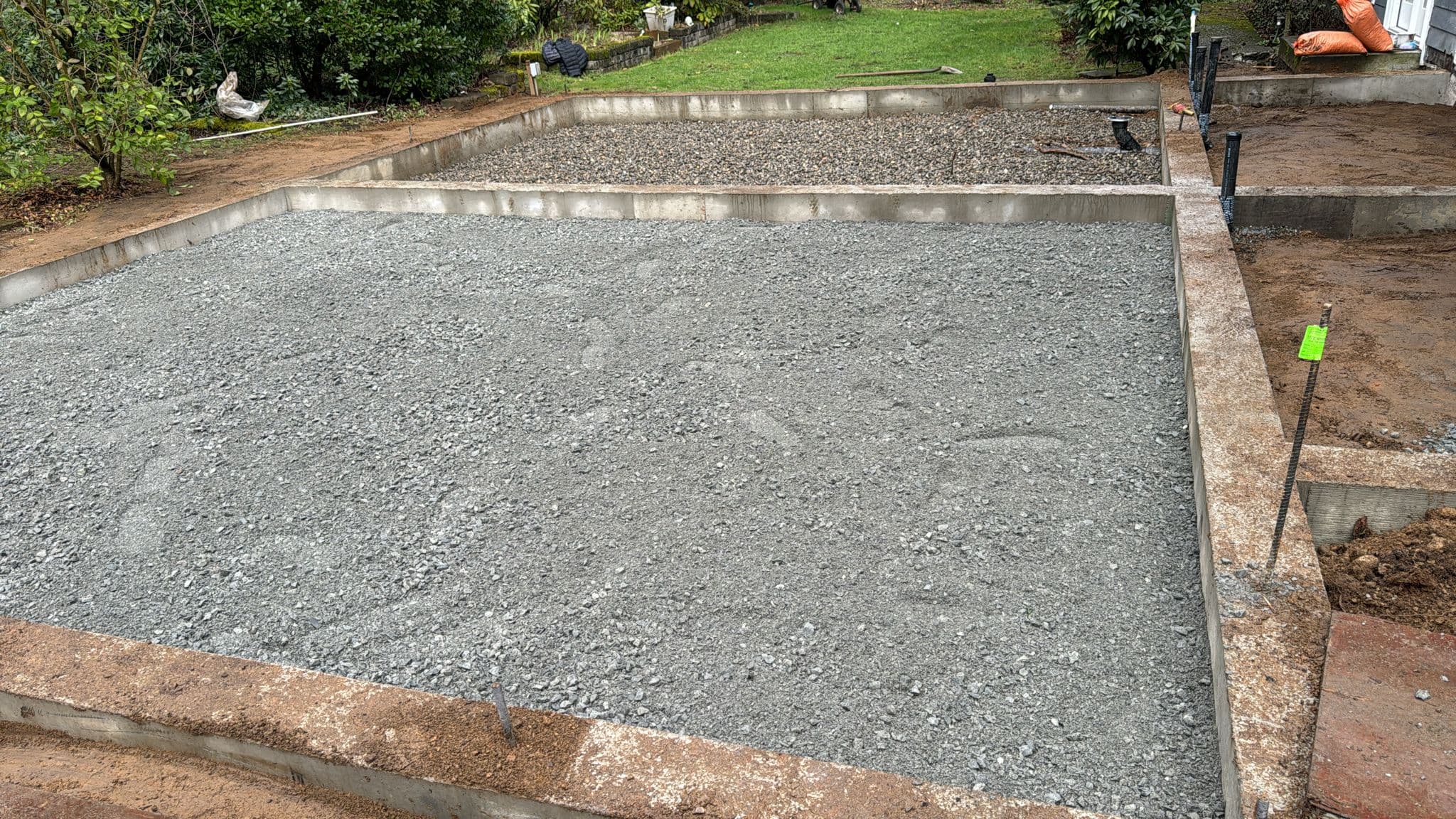 Foundation walls poured + gravel pad